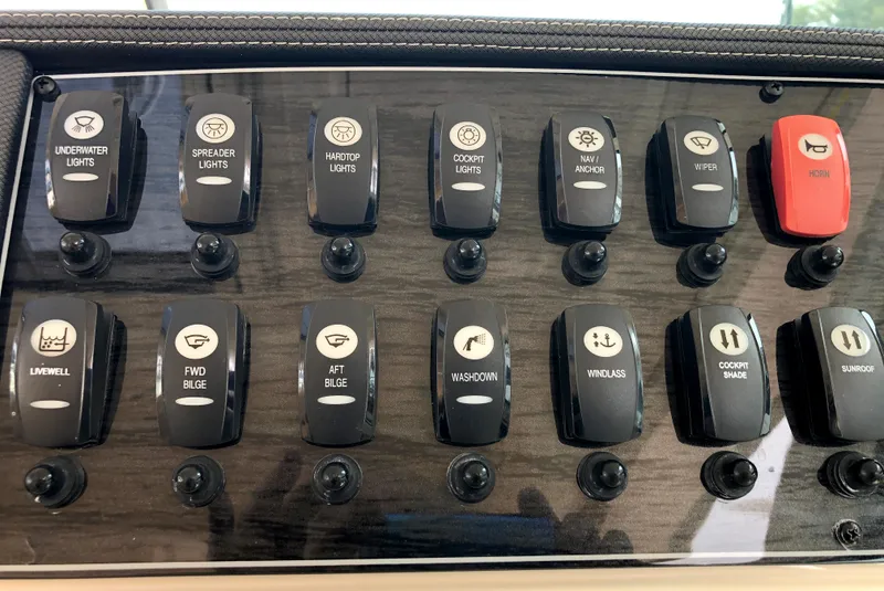 Slide: The Image of Control panel of a 2023 Grady-White Freedom 375 boat with labeled switches. - 18