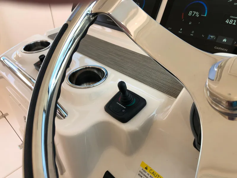 Slide: The Image of Steering wheel and controls of 2023 Grady-White Freedom 375 boat cockpit. - 19