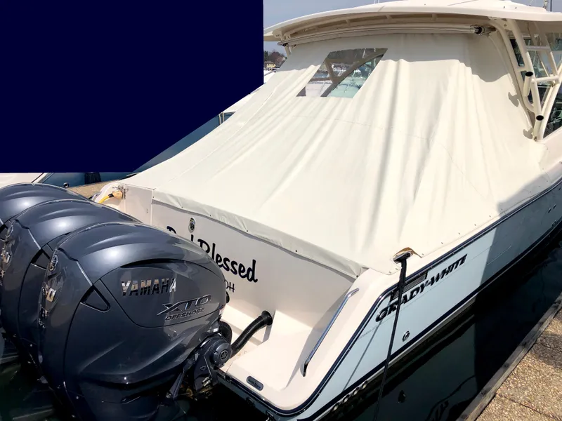 Slide: The Image of 2023 Grady-White Freedom 375 boat with Yamaha engines, docked with a covered cabin. - 2
