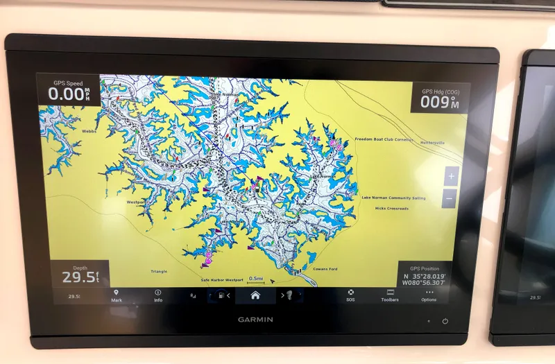 Slide: The Image of Garmin navigation display on 2023 Grady-White Freedom 375 boat, showing detailed marine map. - 21