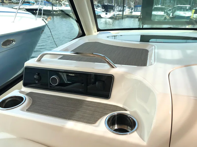Slide: The Image of 2023 Grady-White Freedom 375 boat interior with control panel and cup holders. - 23