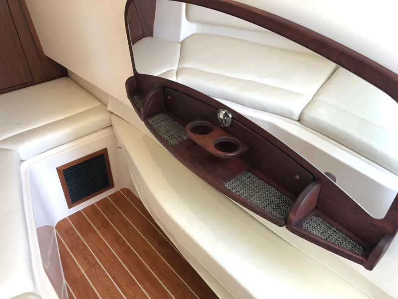 Slide: The Image of 2023 Grady-White Freedom 375 interior with wood accents and white seating. - 27
