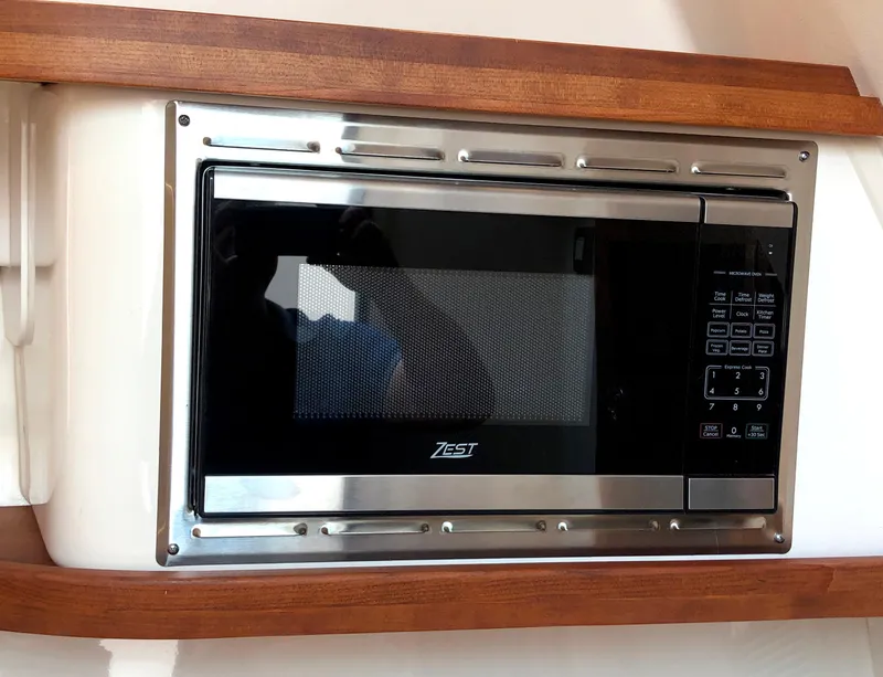 Slide: The Image of Built-in microwave on 2023 Grady-White Freedom 375 boat, featuring stainless steel finish. - 30