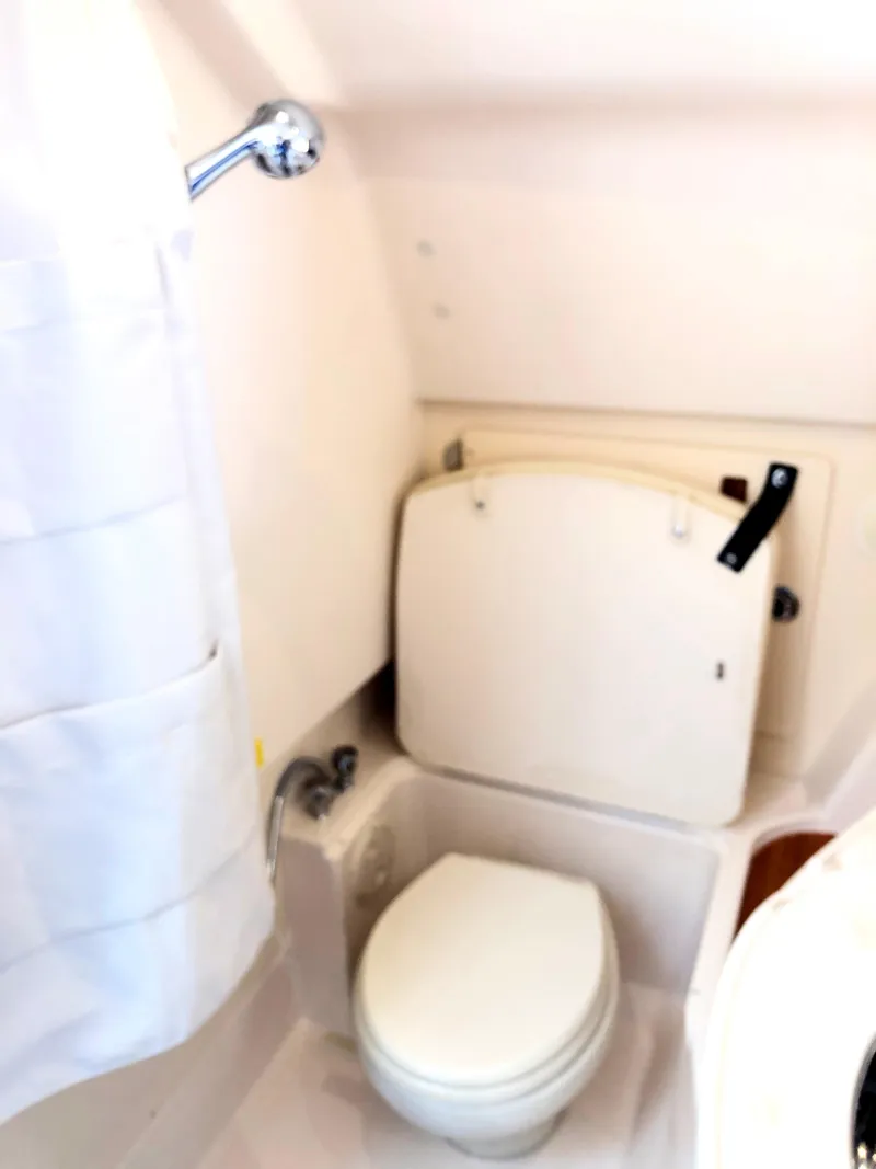 Slide: The Image of 2023 Grady-White Freedom 375 boat bathroom with toilet and shower curtain. - 31