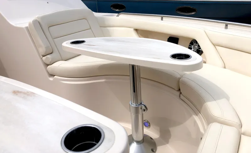 Slide: The Image of 2023 Grady-White Freedom 375 boat interior with cushioned seating and table. - 33