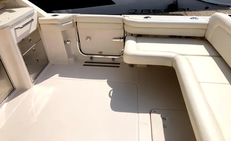 Slide: The Image of 2023 Grady-White Freedom 375 boat interior with white seating and storage compartments. - 7