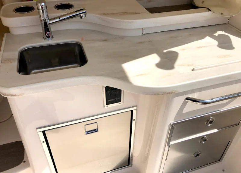 Slide: The Image of Modern kitchenette on 2023 Grady-White Freedom 375 boat with sink and storage. - 8