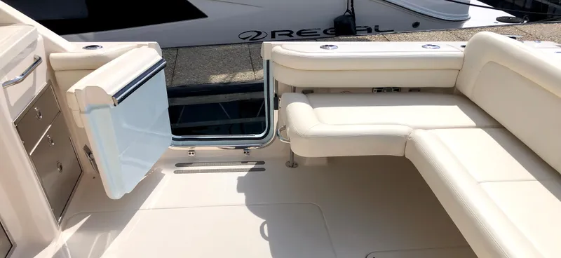 Slide: The Image of 2023 Grady-White Freedom 375 boat interior with open door and seating area. - 9