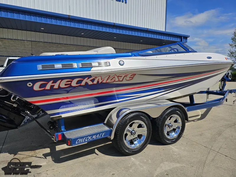 Slide: The Image of 2012 Checkmate ZT 230 BR speedboat on trailer, blue and white design, parked outdoors. - 10