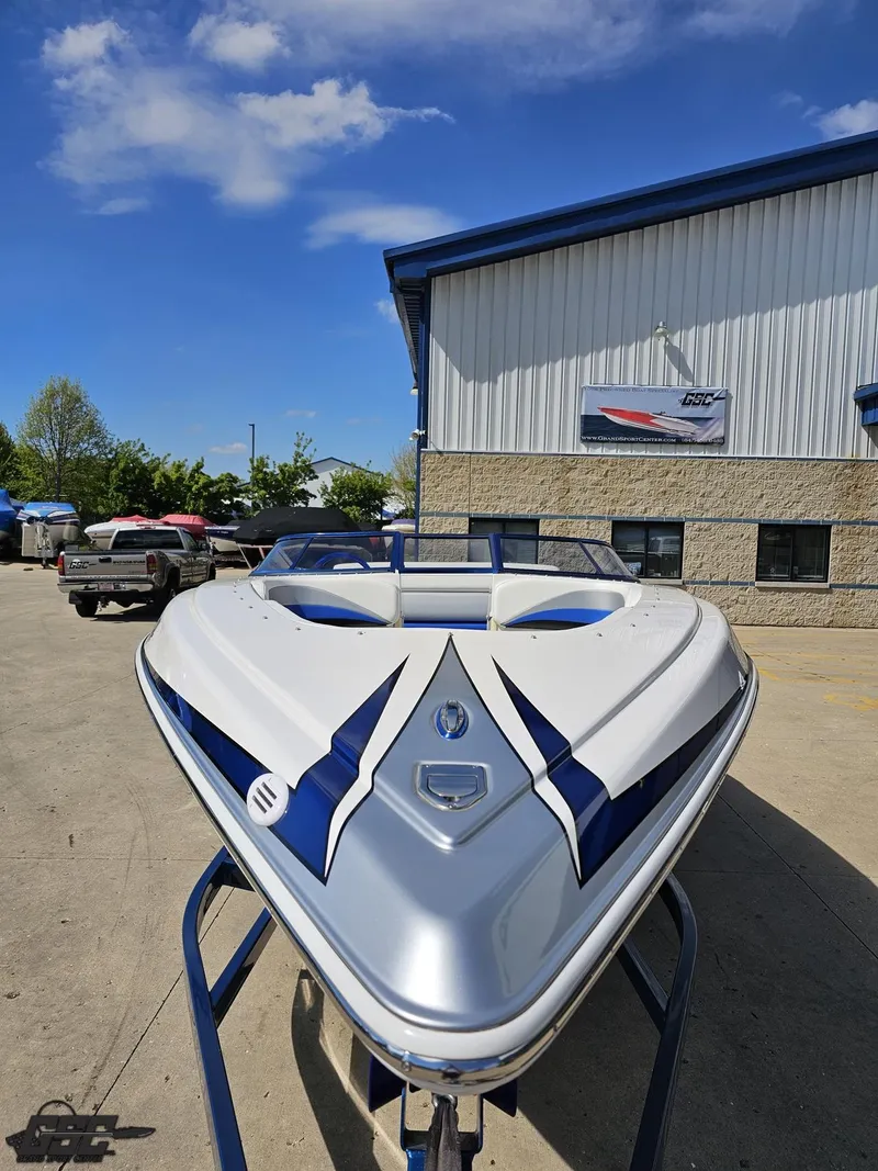 Slide: The Image of 2012 Checkmate ZT 230 BR boat, sleek design, parked outdoors under blue sky. - 15