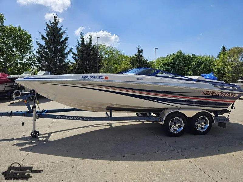 Slide: The Image of 2012 Checkmate ZT 230 BR boat on trailer, parked outdoors on a sunny day. - 18