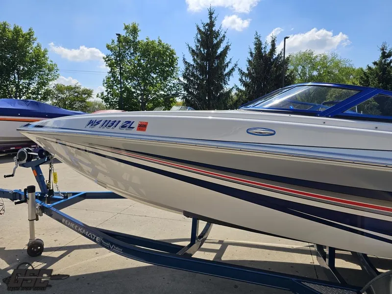Slide: The Image of 2012 Checkmate ZT 230 BR boat on trailer, sleek design, parked outdoors. - 20