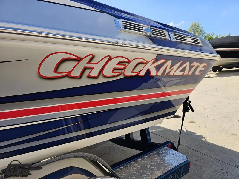 Slide: The Image of 2012 Checkmate ZT 230 BR boat with bold red and blue graphics on the side. - 22