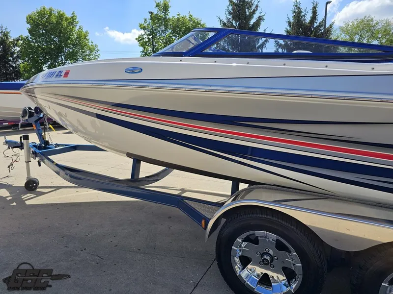 Slide: The Image of 2012 Checkmate ZT 230 BR boat on trailer, featuring sleek design and vibrant stripes. - 23