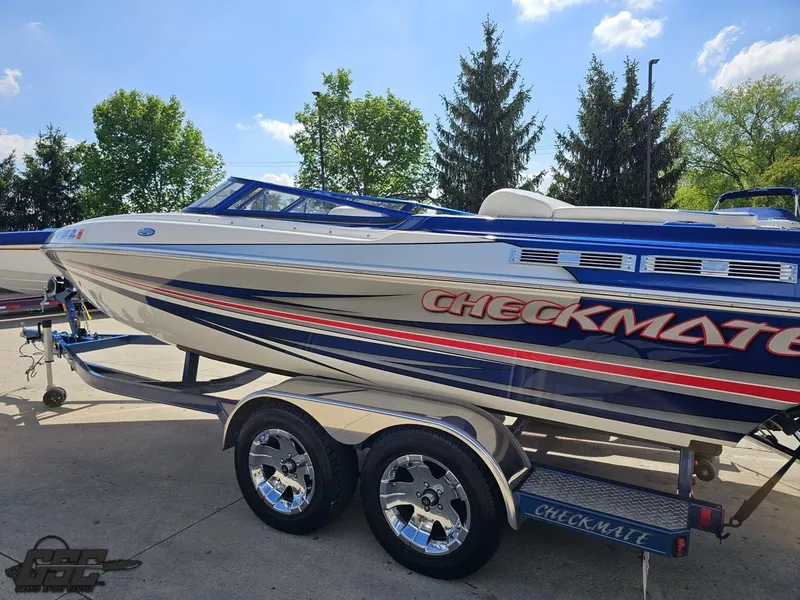 Slide: The Image of 2012 Checkmate ZT 230 BR speedboat on trailer, featuring sleek design and vibrant graphics. - 24