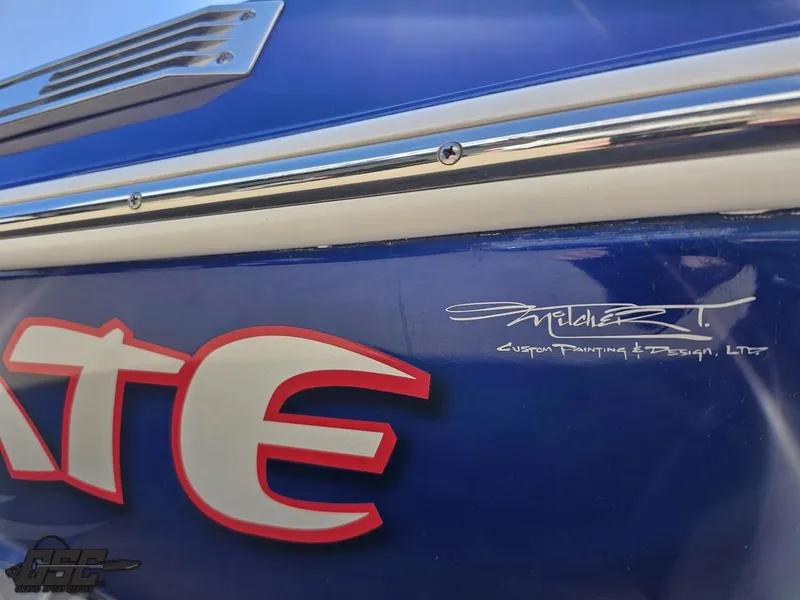 Slide: The Image of 2012 Checkmate ZT 230 BR boat with custom blue paint and design details. - 26