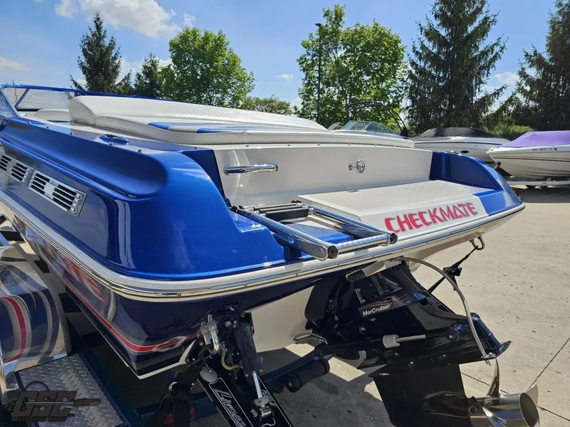 Slide: The Image of 2012 Checkmate ZT 230 BR boat, blue and white, parked outdoors on a sunny day. - 27