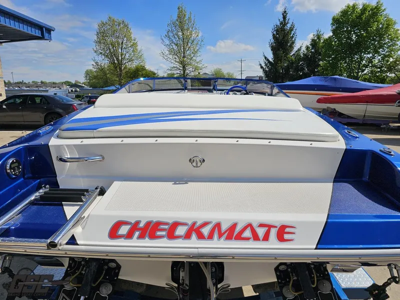 Slide: The Image of 2012 Checkmate ZT 230 BR boat, blue and white design, parked outdoors. - 29