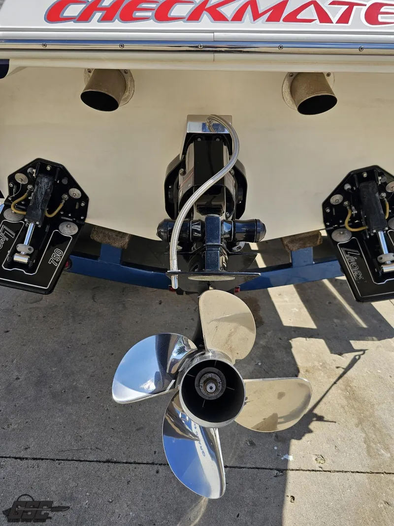 Slide: The Image of 2012 Checkmate ZT 230 BR boat stern with dual exhaust and polished propeller. - 30