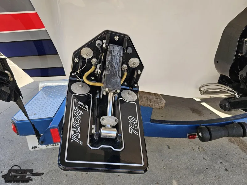 Slide: The Image of Trim tab of a 2012 Checkmate ZT 230 BR boat on a trailer. - 33