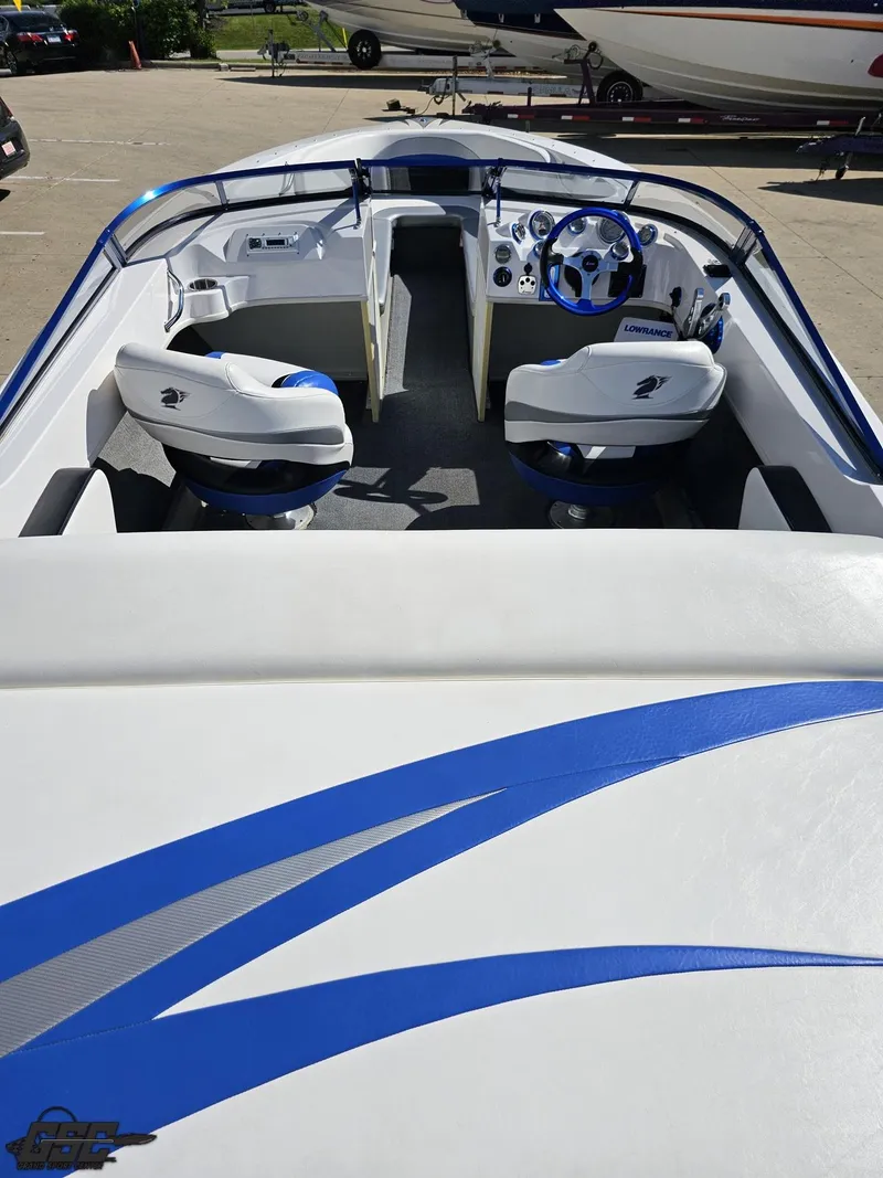 Slide: The Image of 2012 Checkmate ZT 230 BR boat interior with blue and white seating and steering wheel. - 40