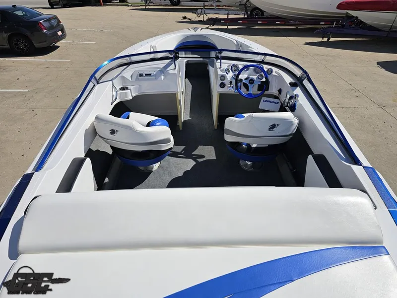 Slide: The Image of 2012 Checkmate ZT 230 BR boat interior with blue and white seating and steering wheel. - 44