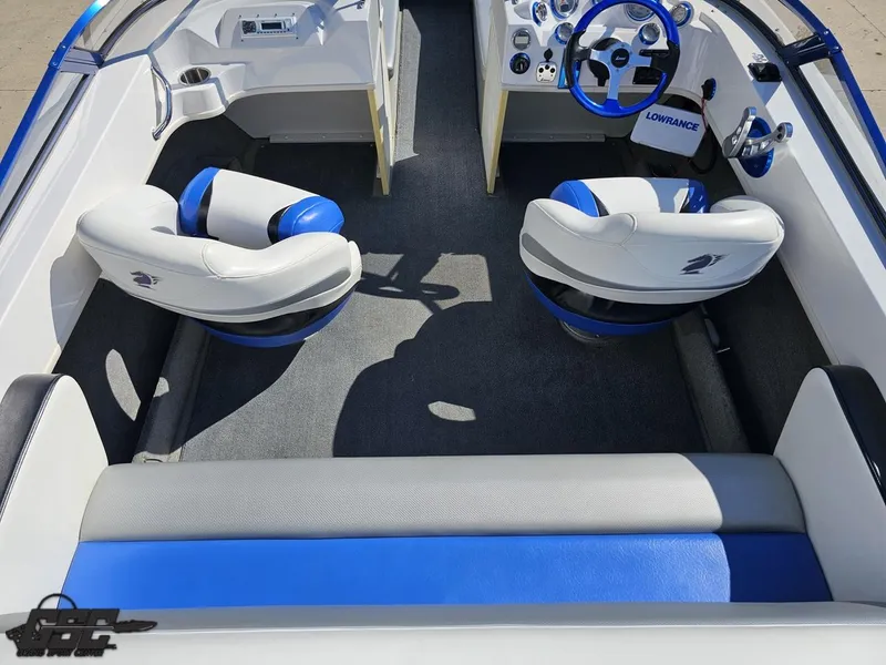 Slide: The Image of Interior of 2012 Checkmate ZT 230 BR boat with blue and white seating. - 48