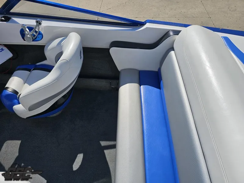 Slide: The Image of Interior of a 2012 Checkmate ZT 230 BR boat with blue and white seating. - 49