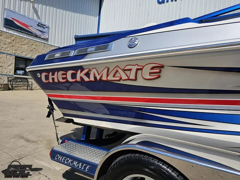 Slide: The Image of 2012 Checkmate ZT 230 BR boat with bold graphics, parked outdoors. - 8