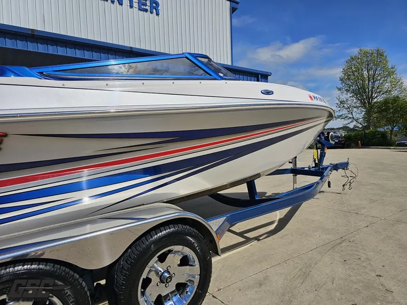 Slide: The Image of 2012 Checkmate ZT 230 BR boat on trailer, featuring sleek design and vibrant stripes. - 9