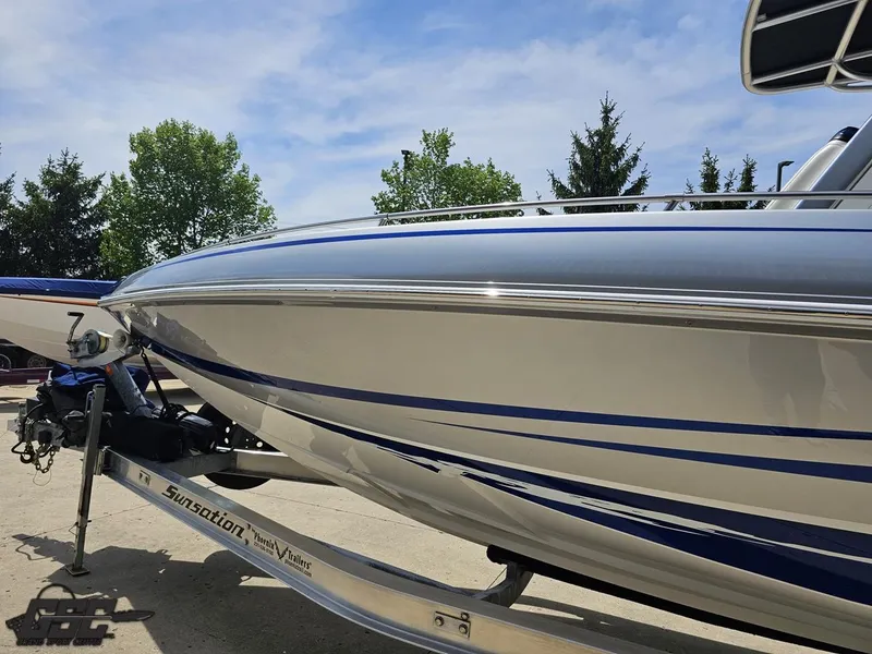 Slide: The Image of 2017 Sunsation 29 CCX boat on trailer, sleek design, blue accents, outdoor setting. - 16