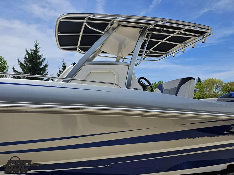 Slide: The Image of 2017 Sunsation 29 CCX boat with sleek design and T-top under blue sky. - 17