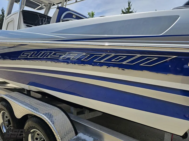 Slide: The Image of 2017 Sunsation 29 CCX boat with blue and white detailing on a trailer. - 23