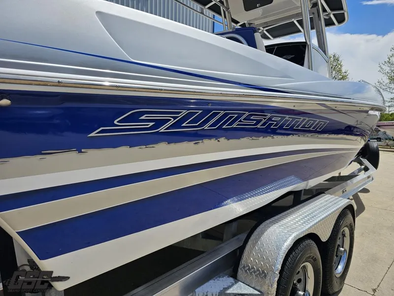 Slide: The Image of 2017 Sunsation 29 CCX boat on trailer, featuring sleek blue and white design. - 32