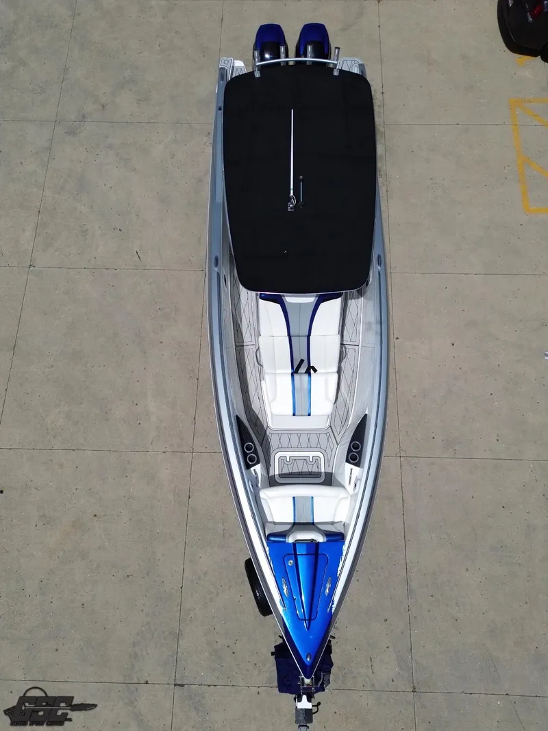 Slide: The Image of 2017 Sunsation 29 CCX boat, aerial view, sleek design, dual engines, blue and white color scheme. - 34