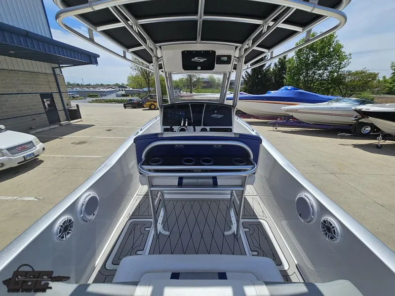 Slide: The Image of 2017 Sunsation 29 CCX boat interior with console and seating, docked outdoors. - 38