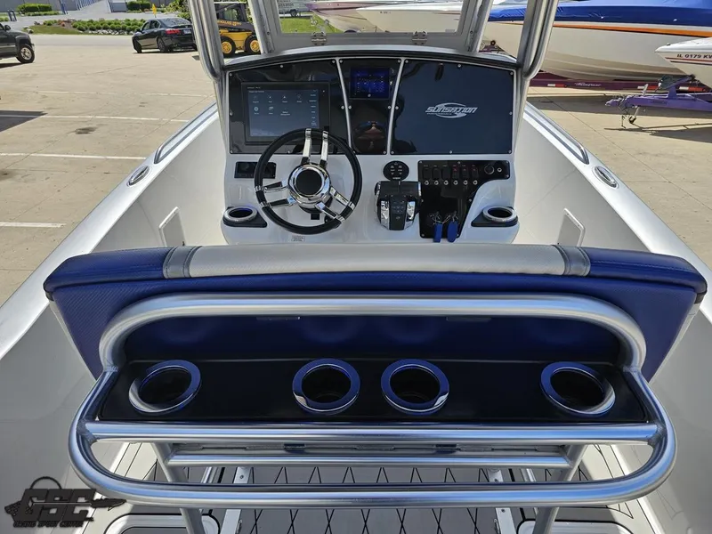 Slide: The Image of 2017 Sunsation 29 CCX boat cockpit with steering wheel, controls, and cup holders. - 49