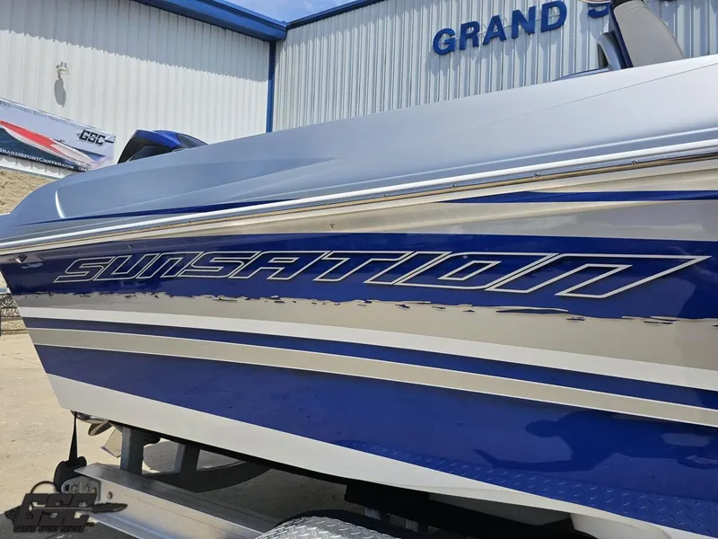 Slide: The Image of 2017 Sunsation 29 CCX boat with blue and silver detailing, displayed outdoors. - 6
