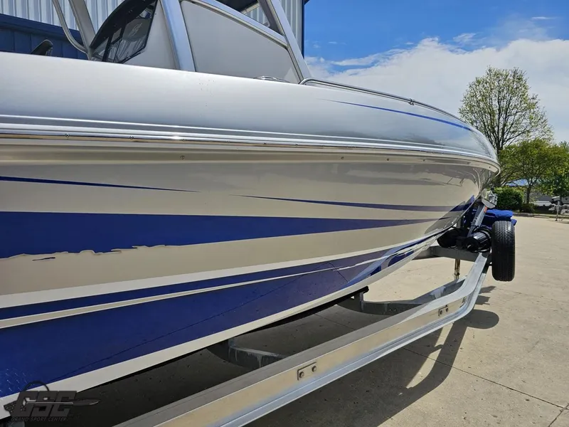 Slide: The Image of 2017 Sunsation 29 CCX boat on trailer, featuring sleek blue and white design. - 7