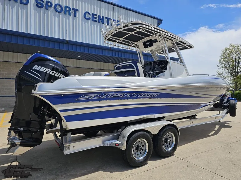 Slide: The Image of 2017 Sunsation 29 CCX boat on trailer, parked outside a sports center. - 9