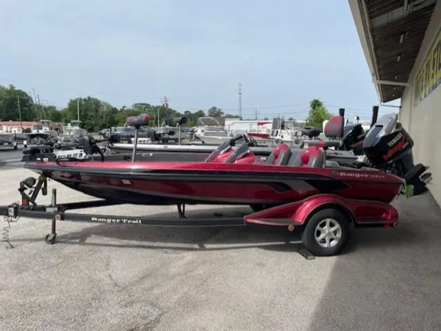 Slide: The Image of 2011 Ranger 188 VX boat on trailer, parked outdoors, red and black color scheme. - 1