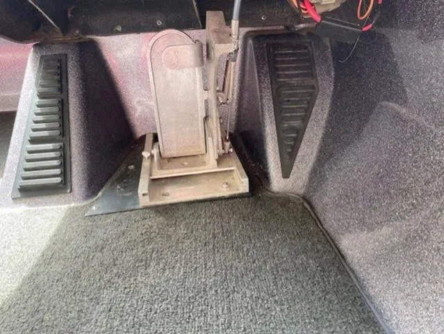 Slide: The Image of Foot pedal area of a 2011 Ranger 188 VX boat, showing carpeted flooring and pedal setup. - 13