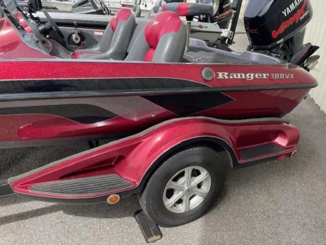 Slide: The Image of 2011 Ranger 188 VX boat with red and black design on a trailer. - 15