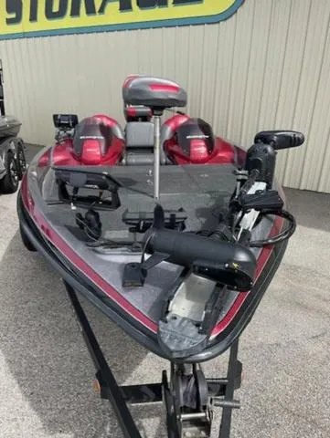 Slide: The Image of 2011 Ranger 188 VX boat with dual seats and mounted equipment, parked outdoors. - 2