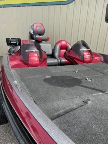 Slide: The Image of 2011 Ranger 188 VX boat with dual seats and red accents, parked near a building. - 7