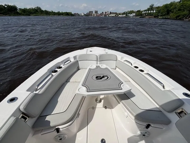 Slide: The Image of 2021 Sea Fox 248 Commander boat interior with seating and table on a calm river. - 11