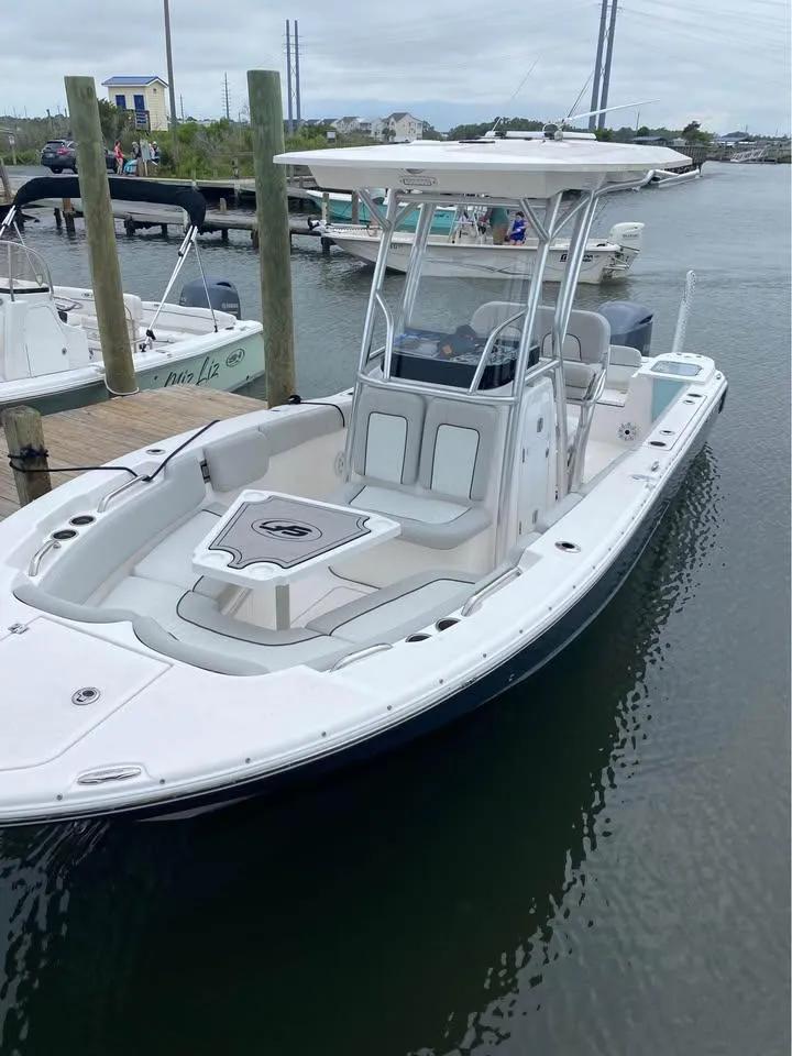 Slide: The Image of 2021 Sea Fox 248 Commander boat docked in a marina, featuring a sleek white design. - 13