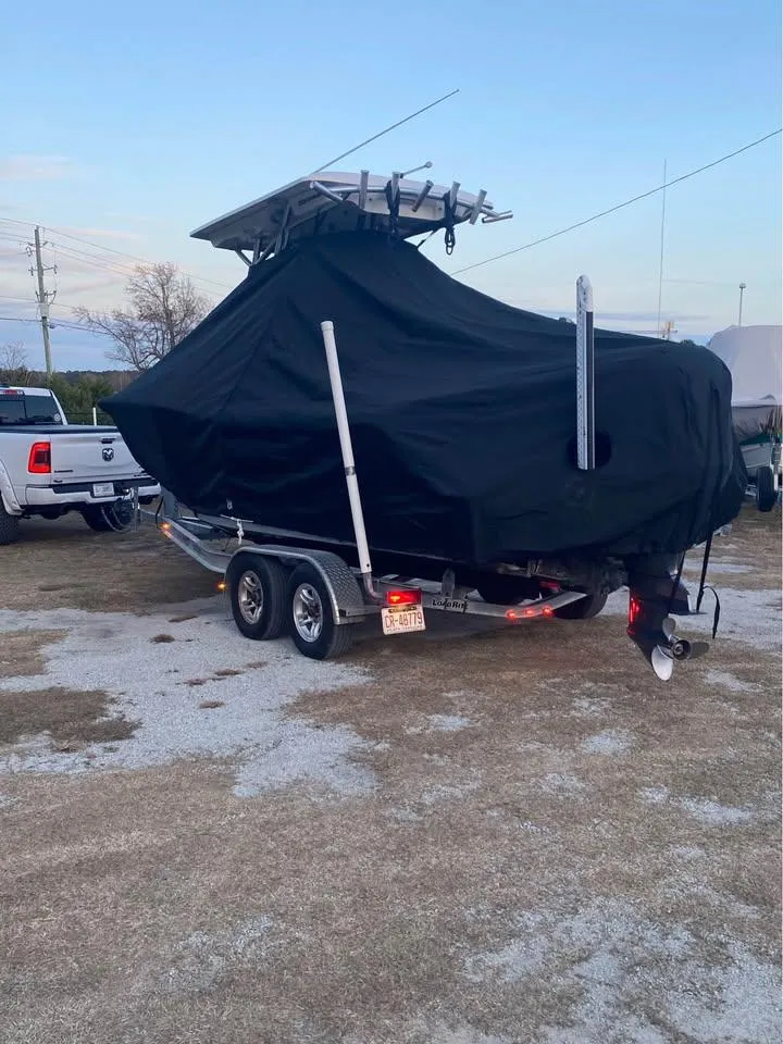 Slide: The Image of 2021 Sea Fox 248 Commander boat covered on trailer, parked outdoors. - 14