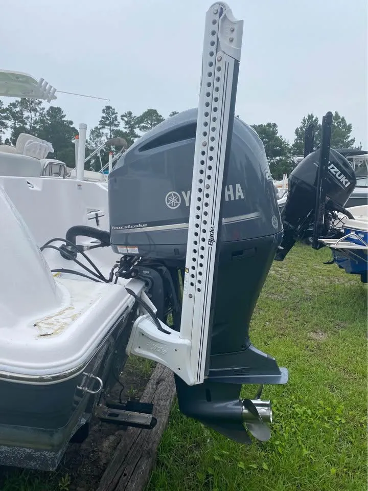 Slide: The Image of 2021 Sea Fox 248 Commander with Yamaha outboard motor, displayed on grassy area. - 16