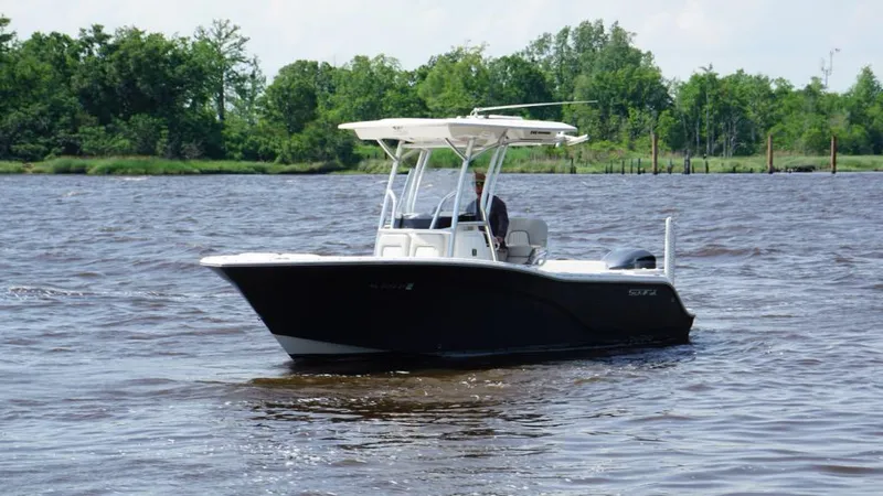 Slide: The Image of 2021 Sea Fox 248 Commander boat on a calm river with lush green trees. - 3